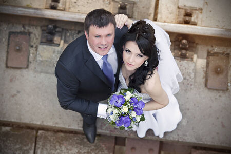 groom and the bride with a wedding bouquet from roses in a hand look upの写真素材