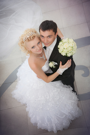 groom and the bride with a wedding bouquet from roses in a hand look upの写真素材