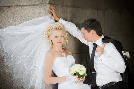 Lovely bride and groom near a bridgeの写真素材