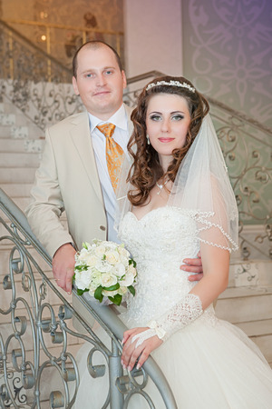 Happy bride and groom on ladder at wedding walkの写真素材