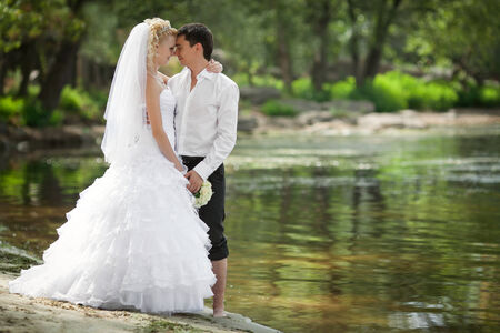 The groom and the bride on a beach in their wedding dayの写真素材