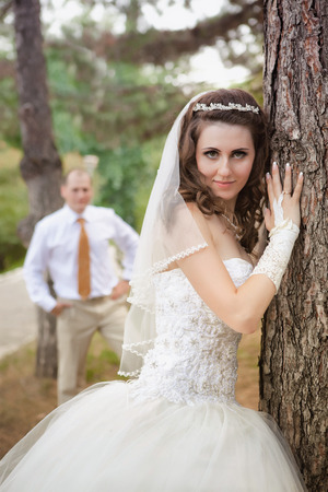 Newly married couple posing in autumn parkの写真素材