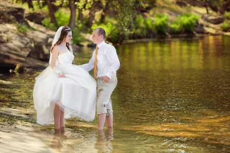The groom and the bride on a beach in their wedding dayの写真素材