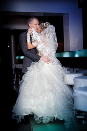 Beautiful young bride and groom next to barの写真素材
