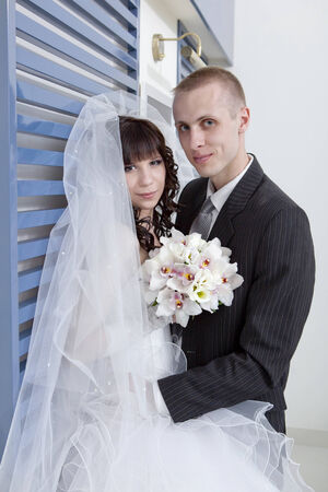 happy bride and groom in the modern hotel hallの写真素材