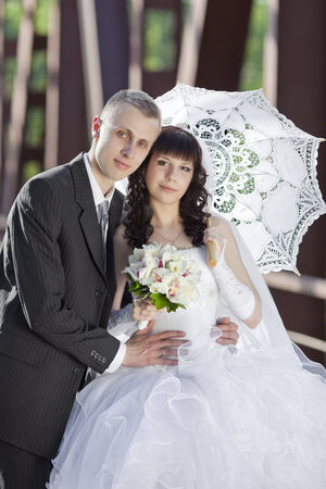 The groom and the bride on the railway bridgeの写真素材