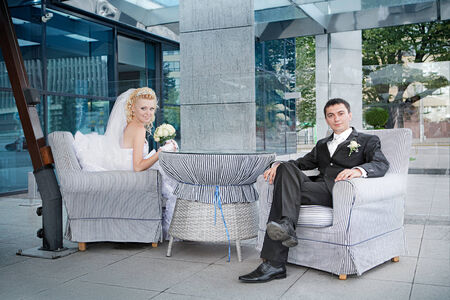 groom  and the bride with a bouquet from roses in cafeの写真素材