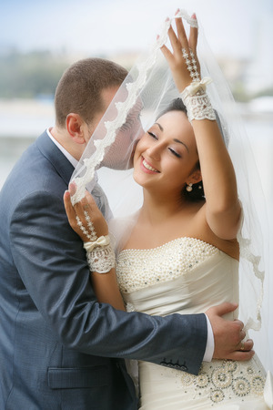 Bride and groom having a romantic moment on their wedding dayの写真素材