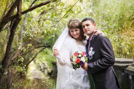 Bride and groom in the autumn parkの写真素材