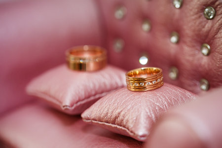 Wedding rings on pink pillows close-upの写真素材