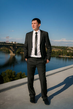 business man in a blue shirt against the blue skyの写真素材