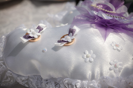 wedding rings lie on a small pillowの写真素材