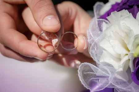 bride and groom holding hands in a ringの写真素材