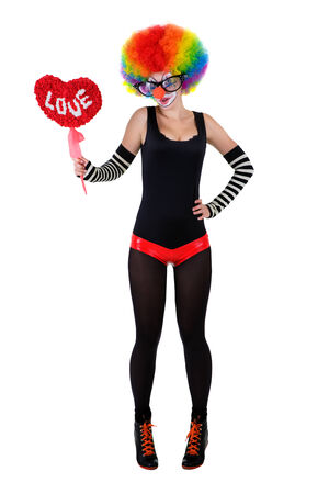 girl in a clown suit holding a red heartの写真素材