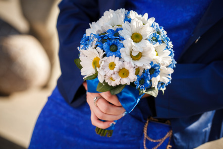 wedding bouquet holds in hands the brideの写真素材