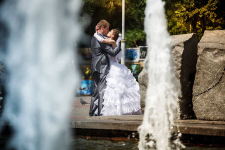 Bride and groom. Wedding walk. City fountain.の写真素材