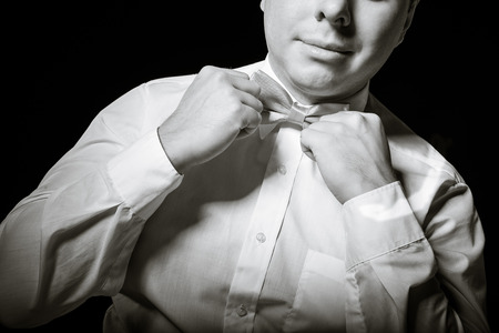Man corrects a necktieの写真素材