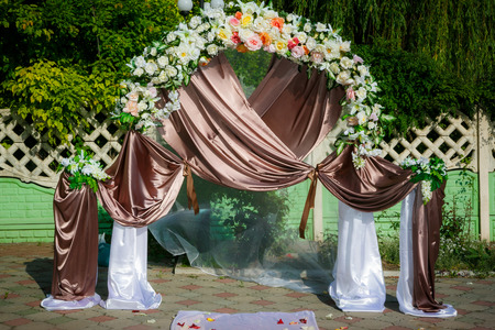 Wedding archway with flowers arranged in park for a wedding ceremonyの写真素材