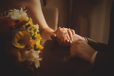 man putting wedding ring on woman handの写真素材