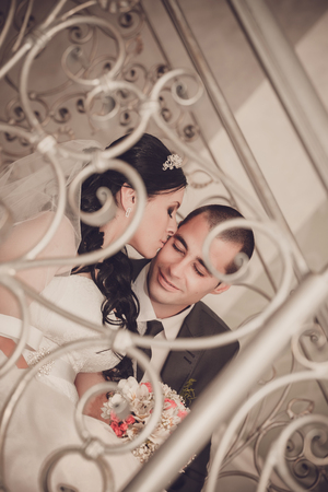 Close up portrait of happy bride and groom on front staircaseの写真素材