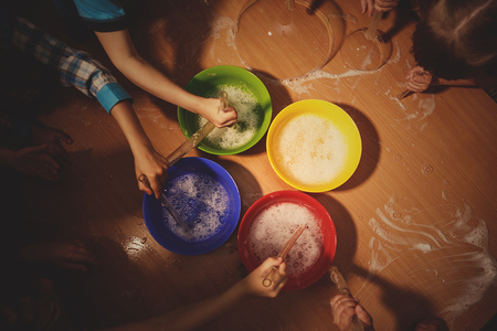 Children are blowing soap bubbles on the tableの写真素材