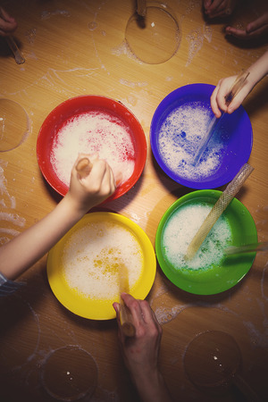Children are blowing soap bubbles on the tableの写真素材