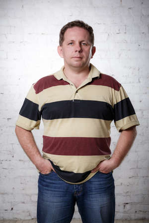 man in a striped t-shirt stands in studioの写真素材
