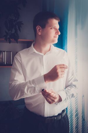 groom or businessman putting on cuff links and he dresses in formal clothesの写真素材