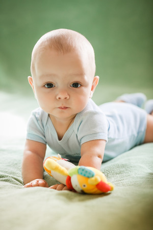 Portrait of  newborn boy is lying in the bedの写真素材