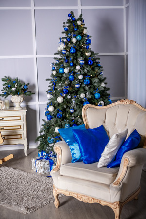 Image of chimney and decorated Christmas tree with giftの写真素材