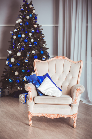 Image of chimney and decorated Christmas tree with giftの写真素材