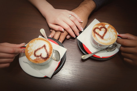 man and woman hands. love and cup coffee concept の写真素材
