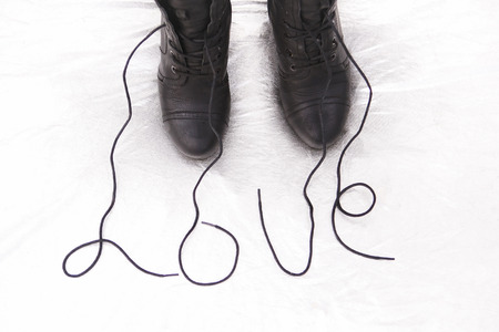 Female  shoes with word love  on the silver  background. Love conceptの写真素材