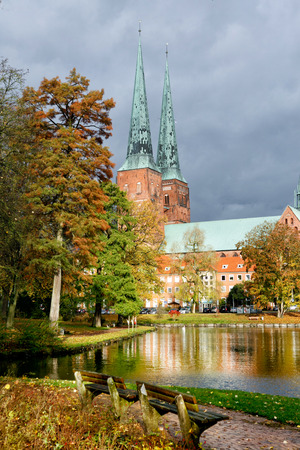 View of Lubeck Cathedral from Muhlenteich (Mill pond) in autumn, Germany. The cathedral was started in 1173 and consecrated in 1247.の写真素材