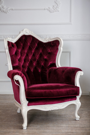 red velour wood armchair  in white roomの写真素材