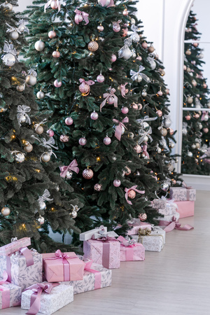 various gifts under beautiful Christmas treesの写真素材