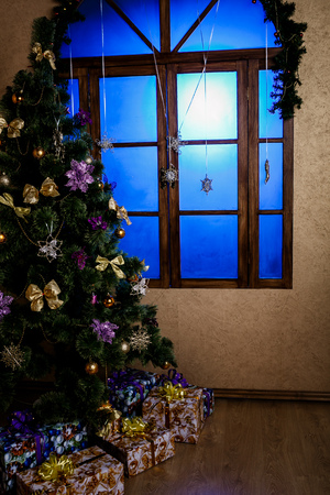 Winter background.Merry Christmas and happy New Year greeting card.Christmas tree with  decorations  and blue lightの写真素材