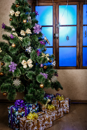 Winter background.Merry Christmas and happy New Year greeting card.Christmas tree with  decorations  and blue lightの写真素材