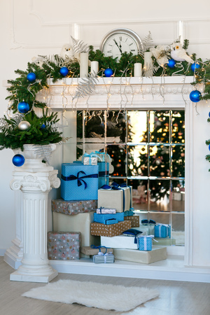 Image of chimney and decorated Christmas tree with giftの写真素材