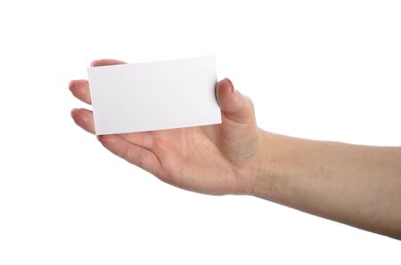 Close-up of an empty business card in a woman's hand isolated on whiteの写真素材