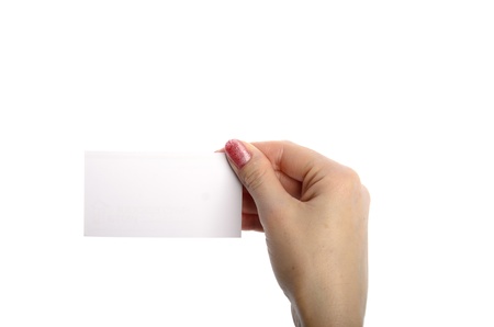 Close-up of an empty business card in a woman's hand isolated on whiteの写真素材