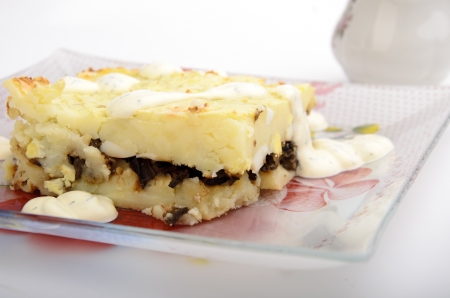 baked potato pudding  on a plate isolated on whiteの写真素材