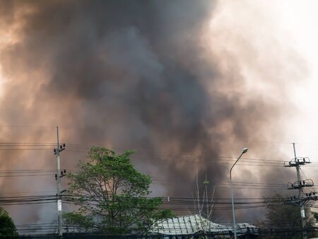 Lamphun, Thailand - April 9, 2016:Fire recycling warehouse, causing a large flame and smoke in the air is very hot days. Firemen rush to help prevent the spread of fire , In Thailand.のeditorial素材
