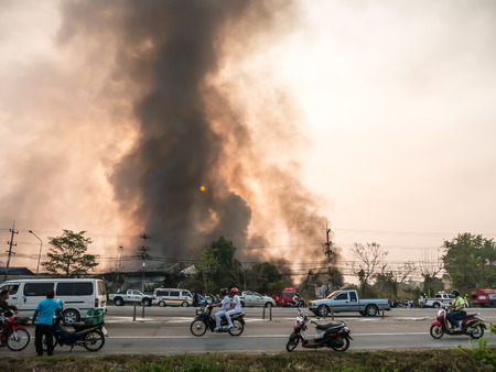 Lamphun, Thailand - April 9, 2016: During the morning April 9, 2016. Fire recycling warehouse, causing a large flame and smoke in the air is very hot days. Firemen rush to help prevent the spread of fire , In Thailand.のeditorial素材