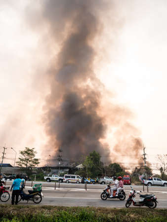Lamphun, Thailand - April 9, 2016: During the morning April 9, 2016. Fire recycling warehouse, causing a large flame and smoke in the air is very hot days. Firemen rush to help prevent the spread of fire , In Thailand.のeditorial素材