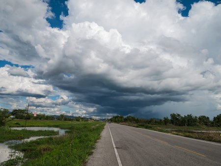 road and clouds on blue sky in rainy season dayの写真素材