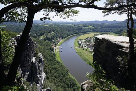 Beautiful view from the Bastei area to Kurort Rathen in Saxon Switzerland, Germanyの写真素材