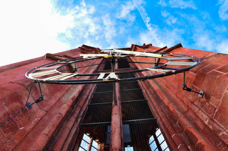 The red tower and the church tower clock of Sint-Janskerk in Maastricht, Netherlandsの写真素材