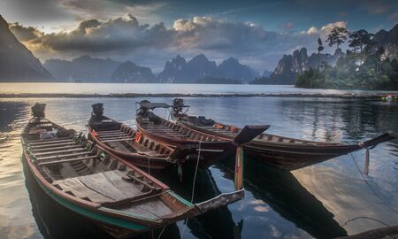 Four ships were parked in a calm lake.の写真素材
