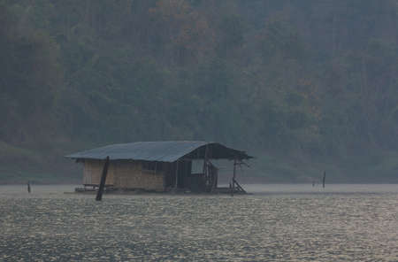 Old raft floating in the mist on the lake in Kanchanaburi, Thailand.の写真素材